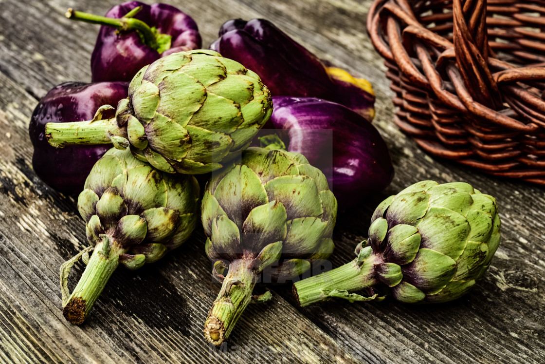 "artichokes and purple bell peppers on rustic wood" by Marie Kazalia - $15.16 "artichokes and purple bell peppers on rustic wood" stock image