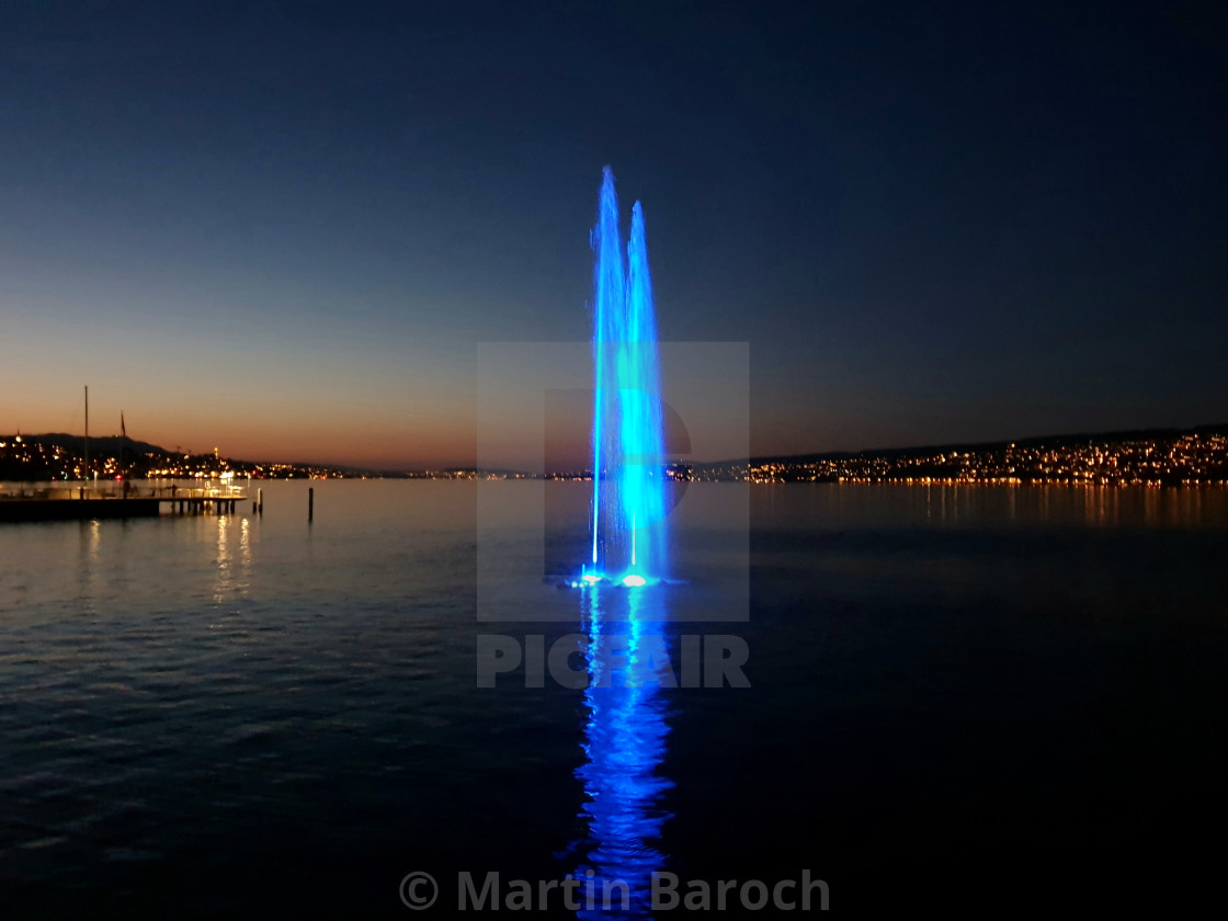 "Illuminated water jet at sunset" stock image