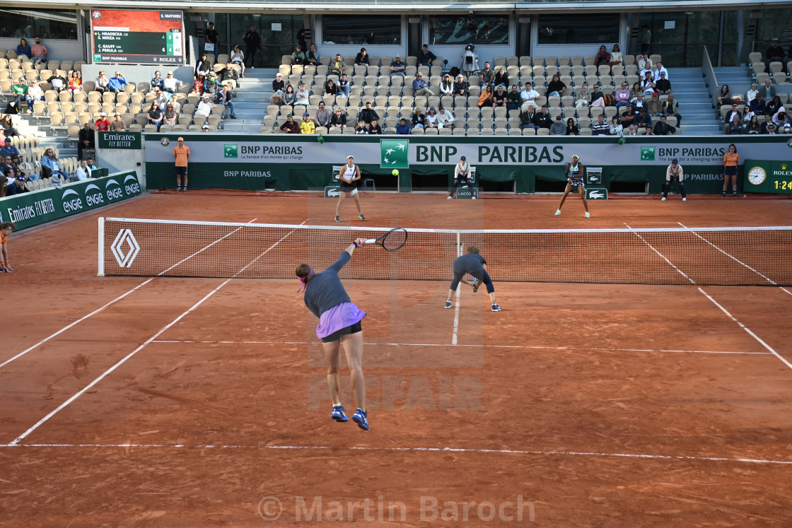 "Lucie Hradecka serving in a doubles match" stock image