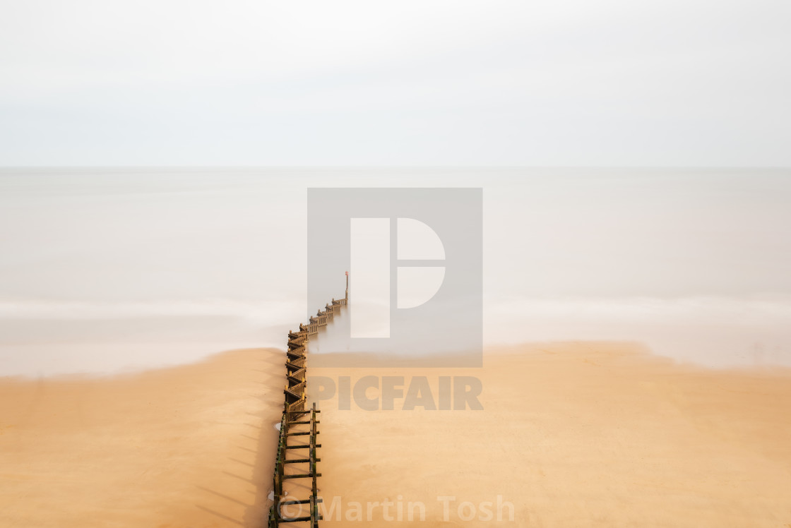 "Zig zag sea groyne and soft wave movement." stock image