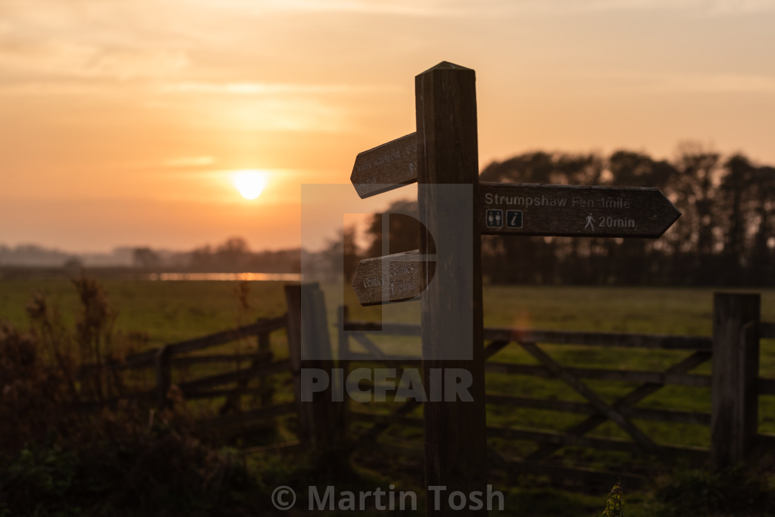 "Fingerpost footpath sign at sunset, Buckenham Marshes." stock image