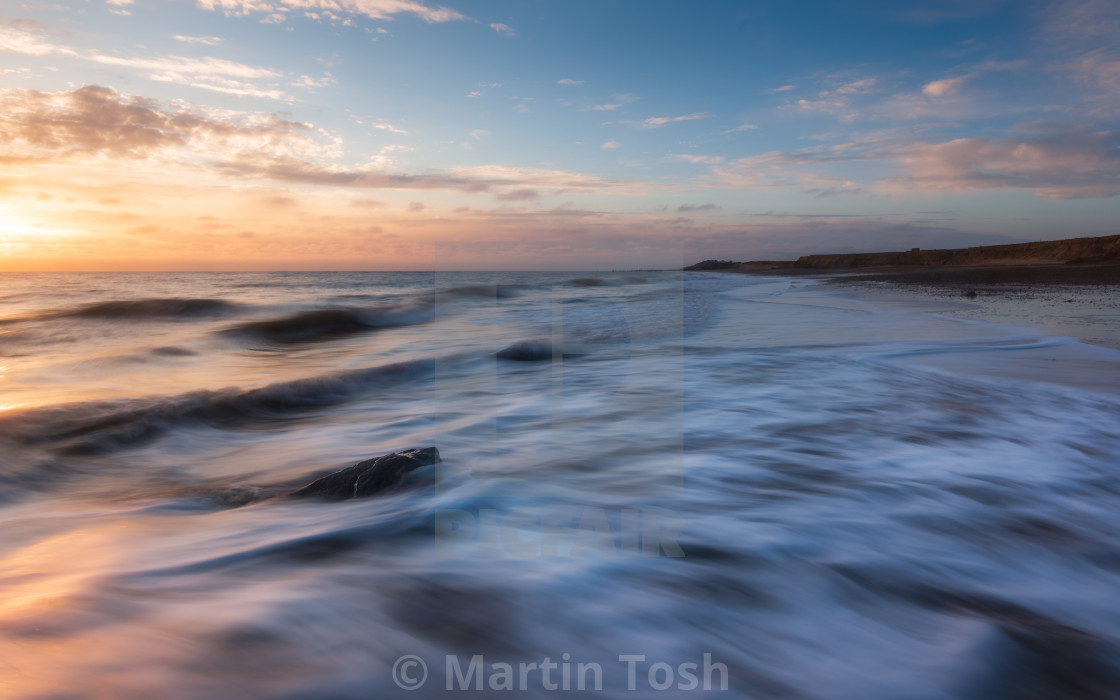 "Soft sunrise glow at Happisburgh beach, Norfolk" stock image