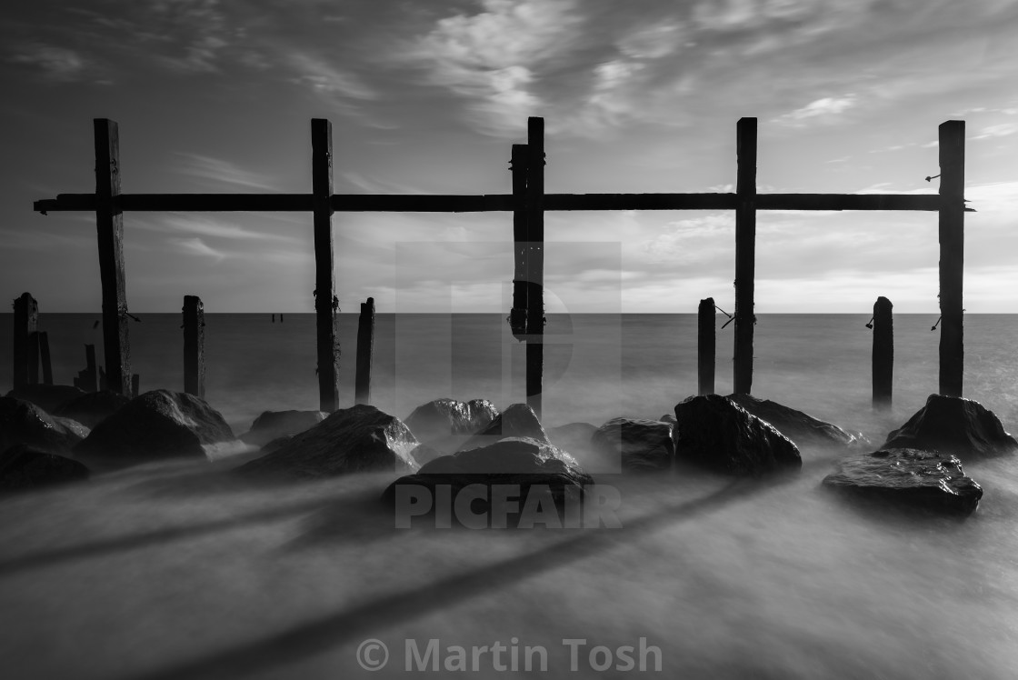 "Derelict sea defences mono on Happisburgh beach, Norfolk" stock image