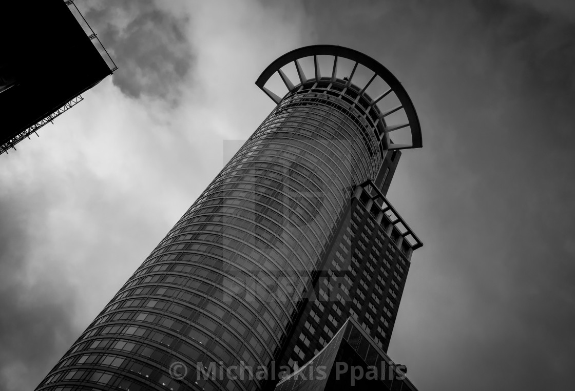 "Modern architecture design of a Skyscraper building. Black and white futuristic exterior against cloudy sky" stock image