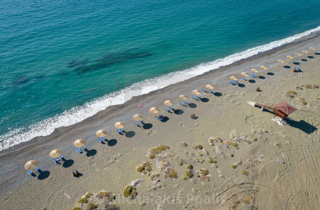 "Aerial view of beach umbrellas in a row and lifeguard station on an empty beach. Paphos Cyprus" stock image