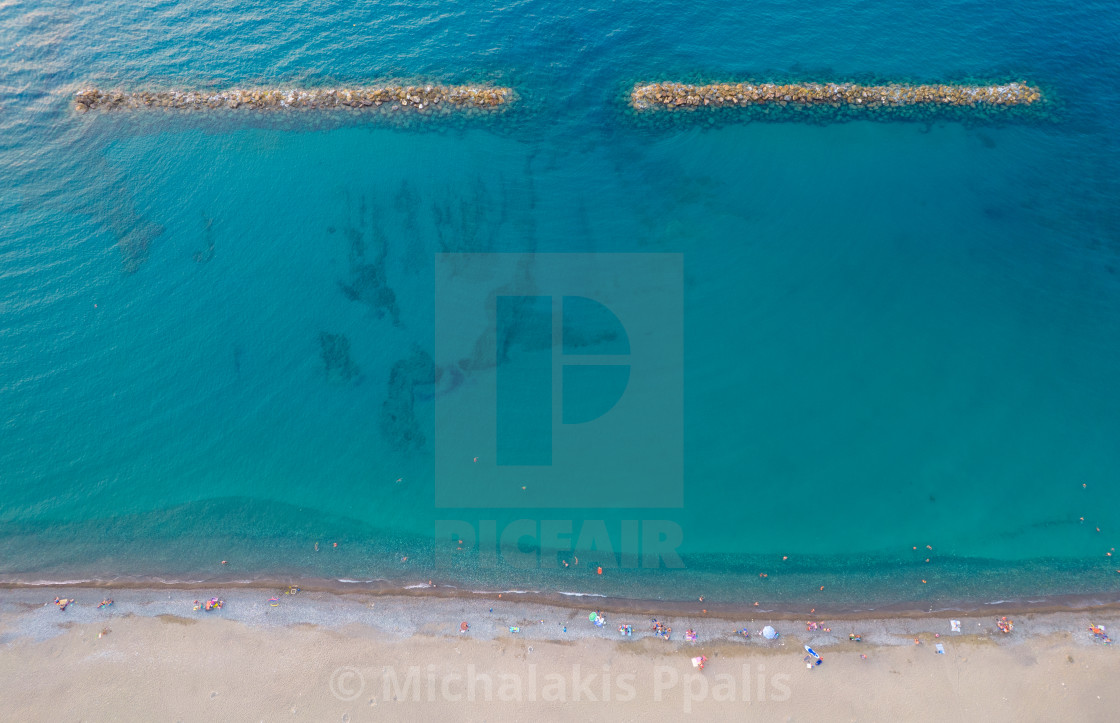 "Aerial view from flying drone of people relaxing on the beach in Paphos Cyprus" stock image