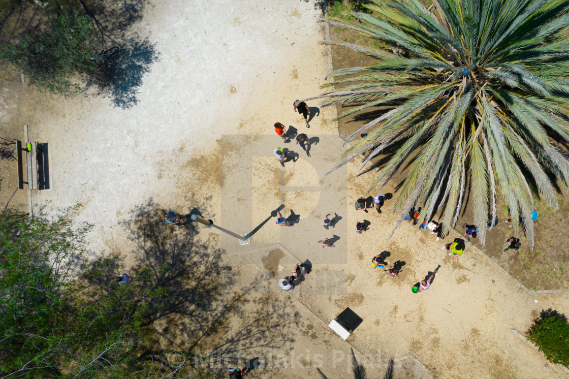 "Unrecognised children playing with water in the park. Aerial view of people having fun" stock image