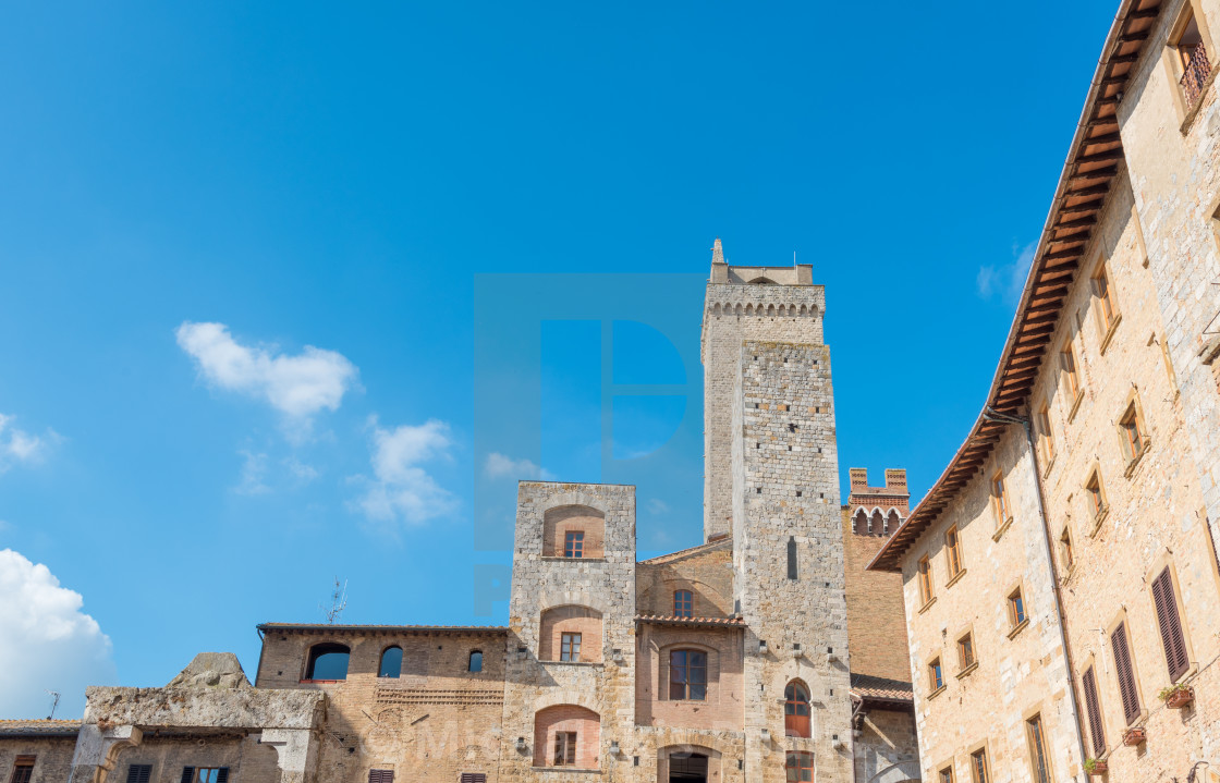 "Historical architecture buildings, San Gimignano city Tuscany, Italy against blue sky" stock image