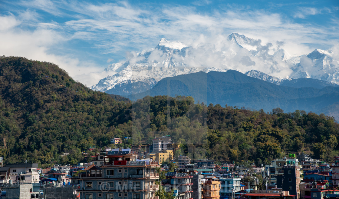 "Pokhara cityscape with the Annapurna mountain range covered in snow at central Nepal, Asia" stock image