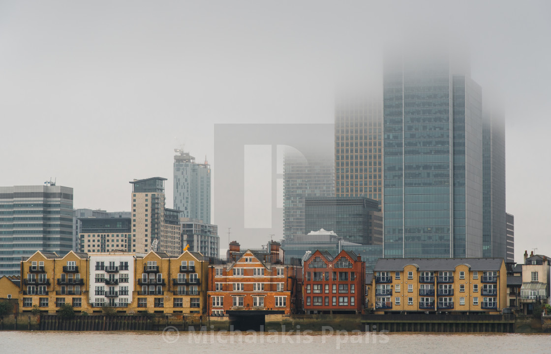 "Skyline of Canary Wharf business centre at mist. London united kingdom" stock image