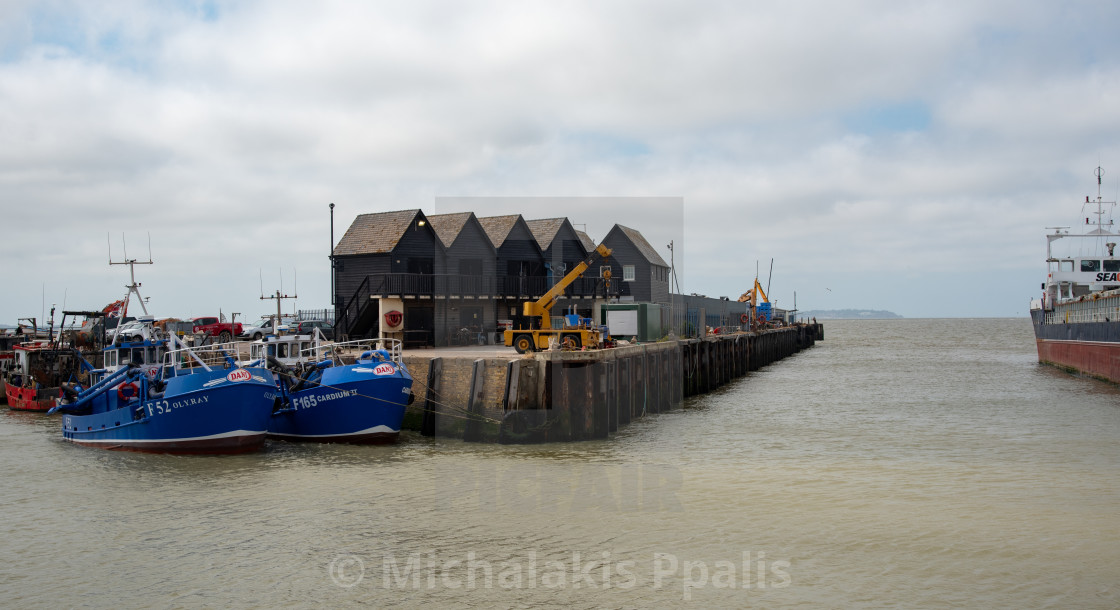 "Fishing boats moored at Whitstable harbor in Kent England" stock image