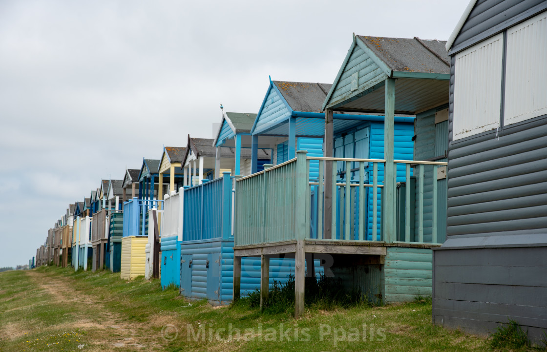 "Colorful holiday beach huts. Vacations coastal wooden houses" stock image