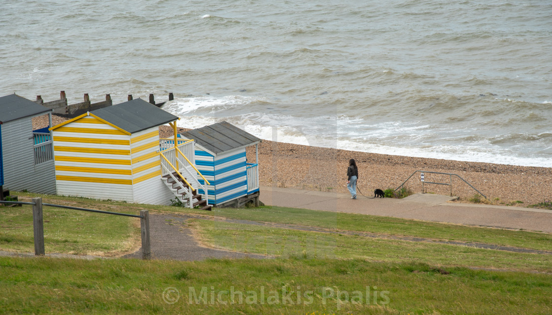 "Colorful holiday beach huts homes facing the calm blue sea." stock image