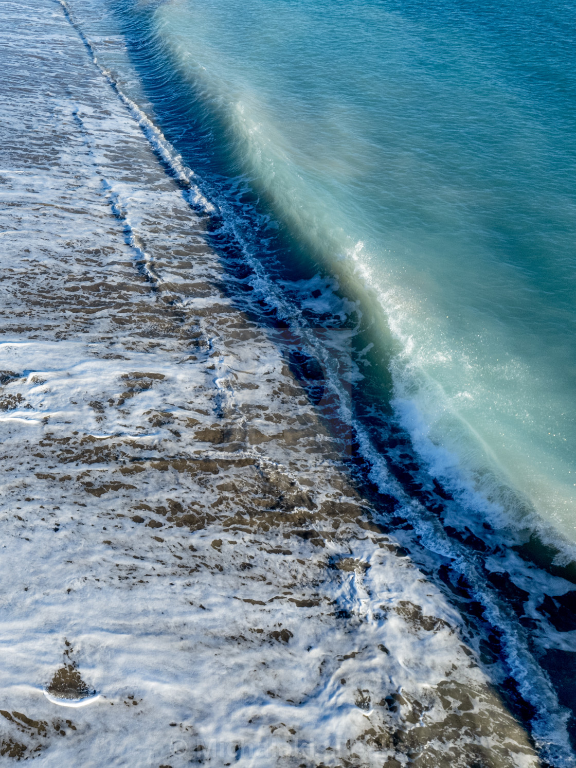 "Aerial view of ocean waves breaking on a sandy beach. Nature background" stock image