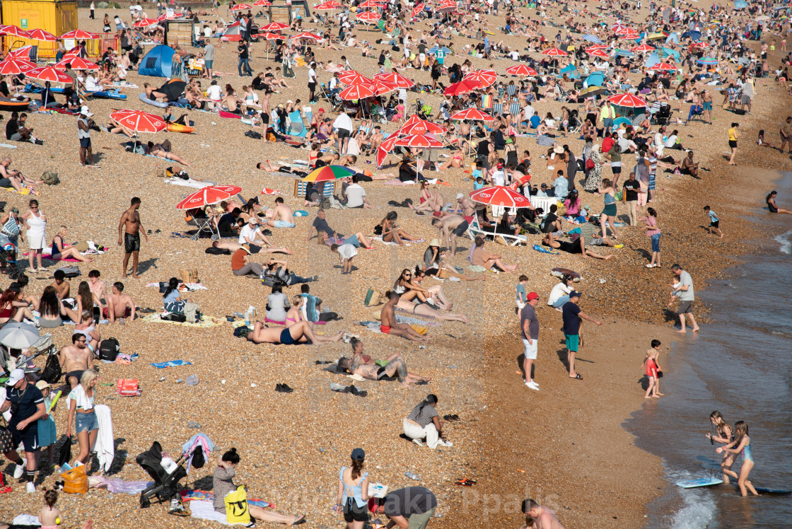 "Crowd of British people sunbathing swimming and relaxing in the beach at summer. Leisure time outdoor" stock image