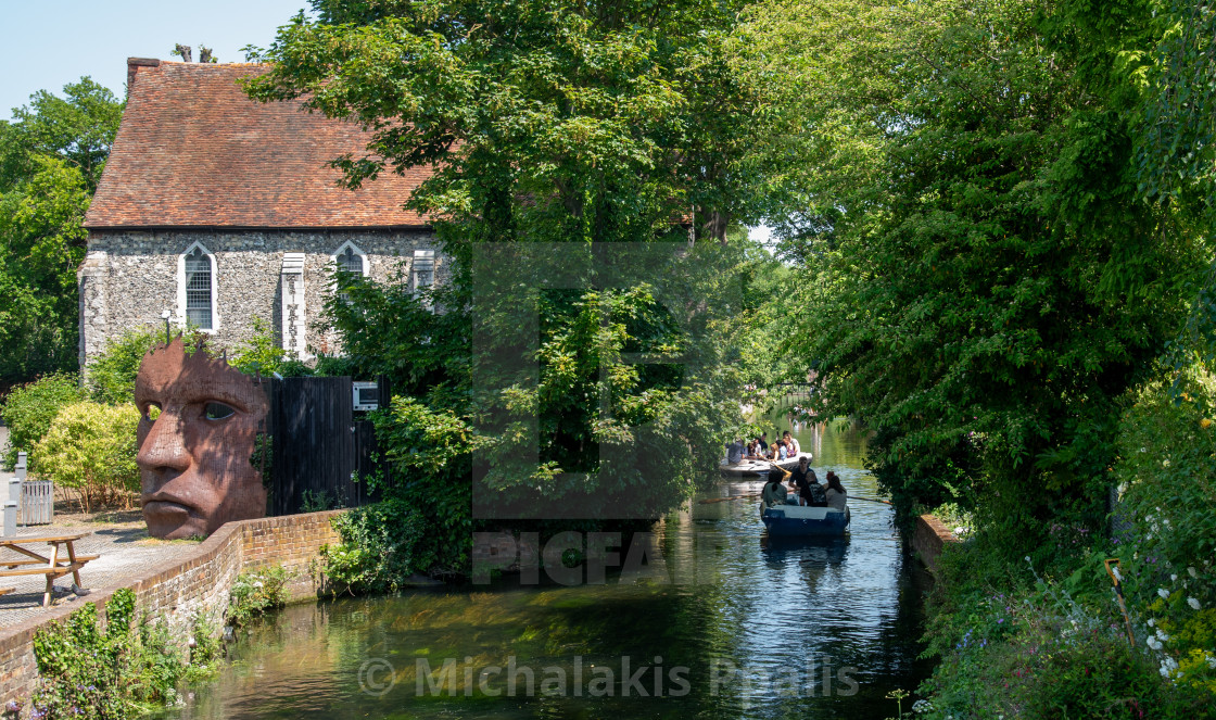 "Chartham gardens with tourist People taking a romantic boat ride in the canal of the river stour." stock image