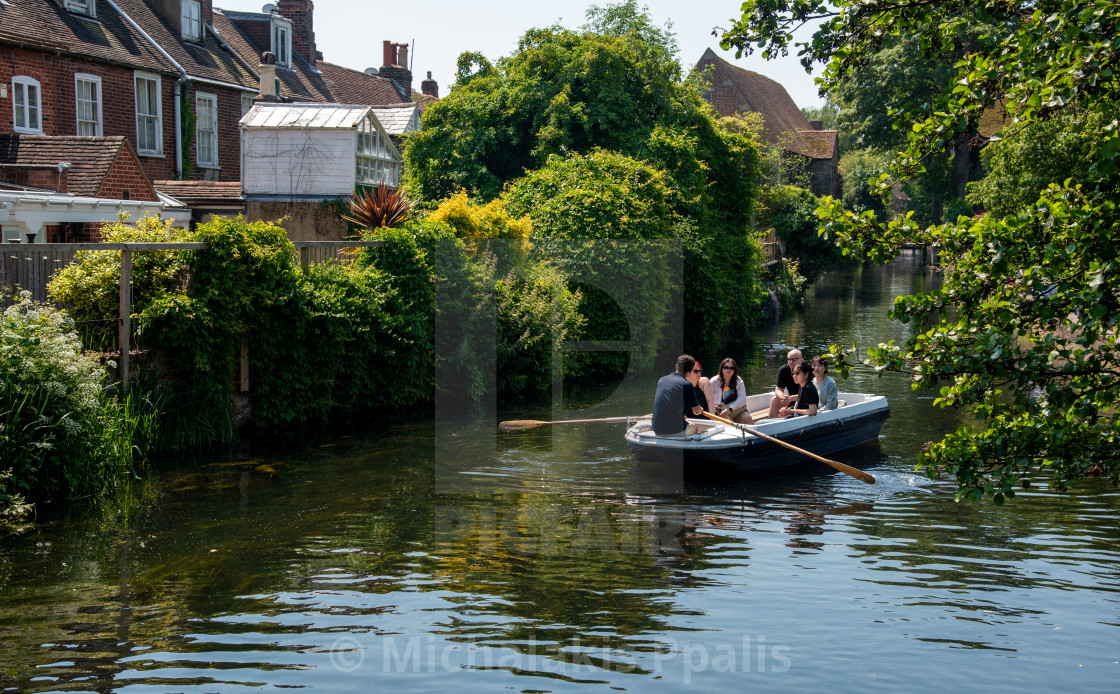 "Chartham gardens with tourist People taking a romantic boat ride in the canal of the river stour." stock image