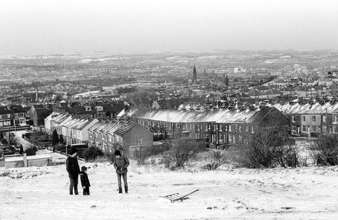 "Beldon Hill, Bradford, West Yorkshire, UK. Two men and a young boy playing in..." stock image