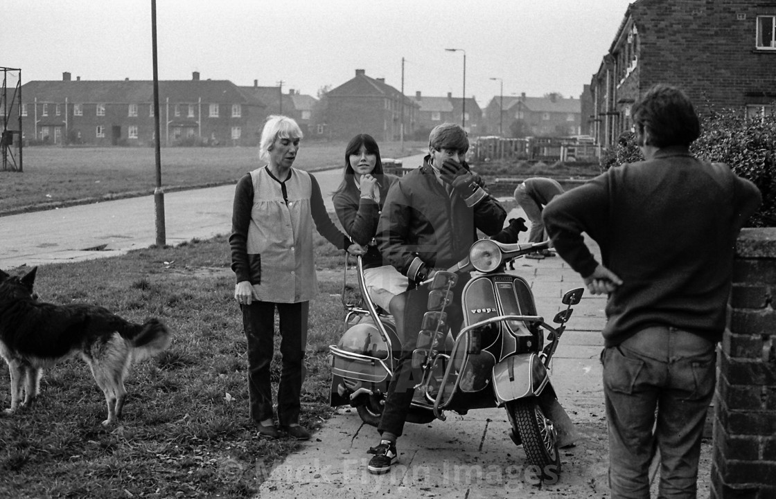 "Family standing beside Vespa motor scooter on Brafferton Arbor, Buttershaw Estate,..." stock image