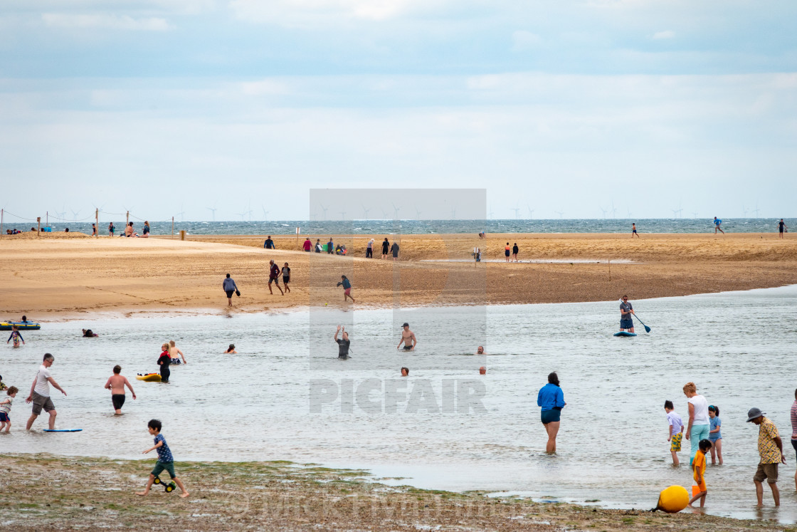 "Wells-next-the-sea North Norfolk, UK, a Muslim staycationer family walk on..." stock image