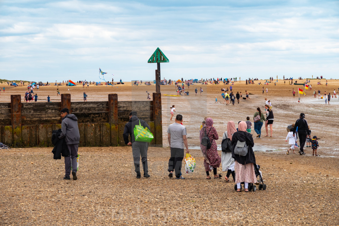 "Wells-next-the-sea North Norfolk, UK, a Muslim staycationer family walk on..." stock image