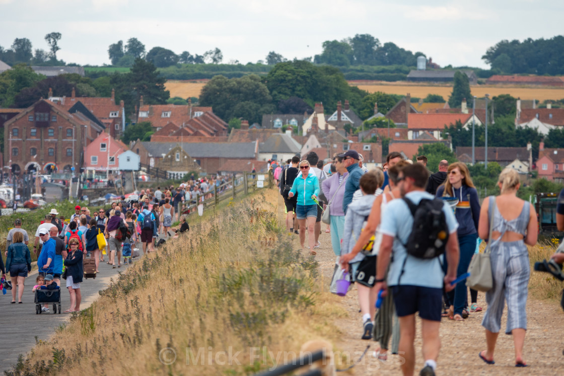 "Staycationers and day trippers walk along a crowded Beach road in..." stock image