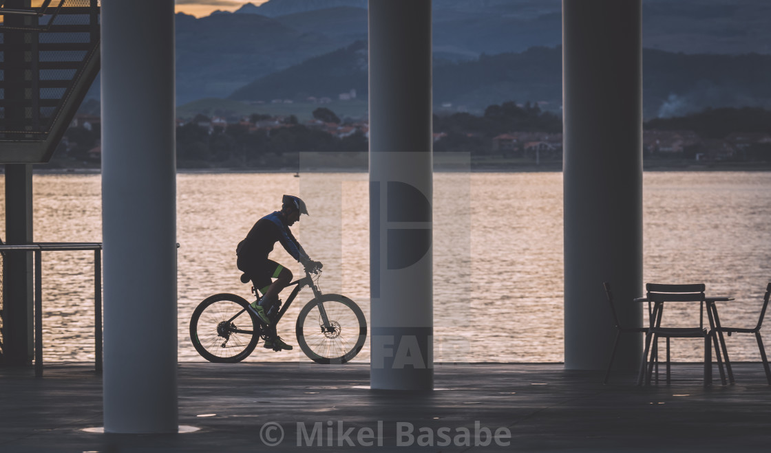 "A biker passing by the Botín Center in Santander, Cantabria, Spain" stock image