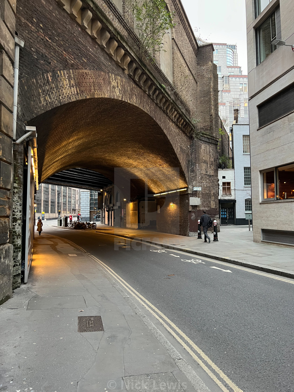 "Walking along Crutched Friars in London and about to pass under a bridge near..." stock image