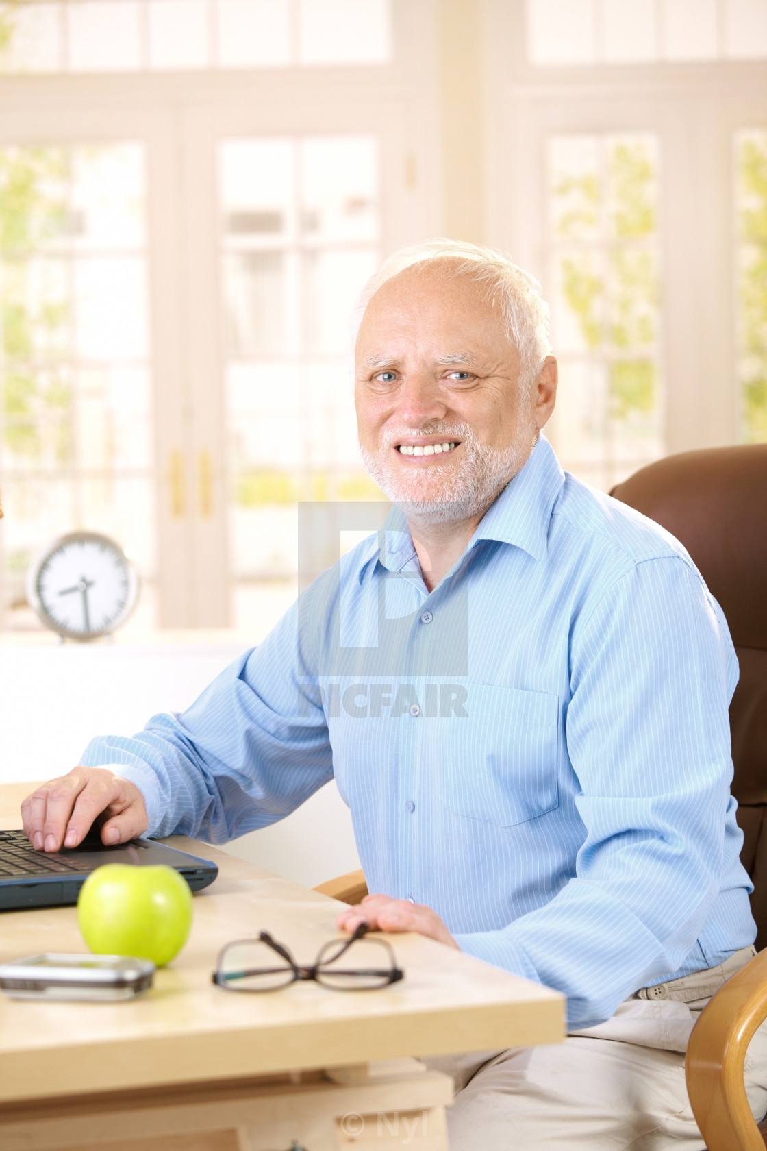 "Portrait of senior man at desk" stock image