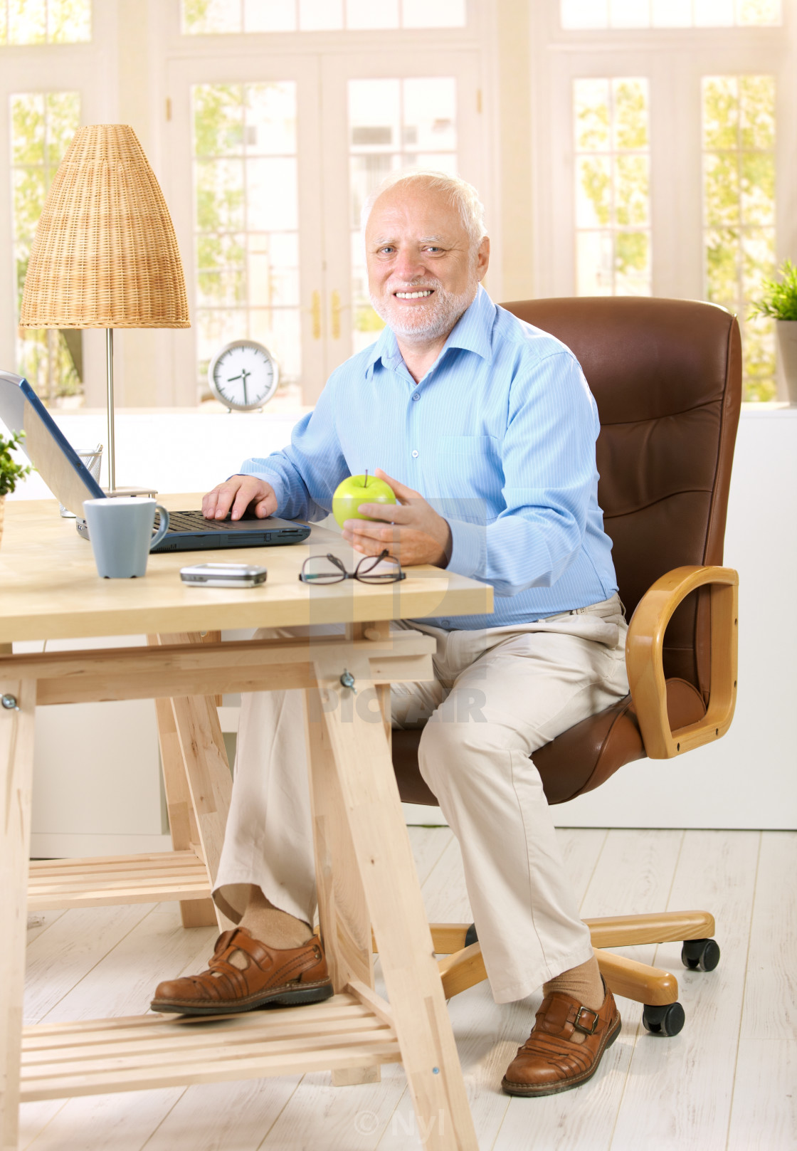 "Older man working in his study" stock image