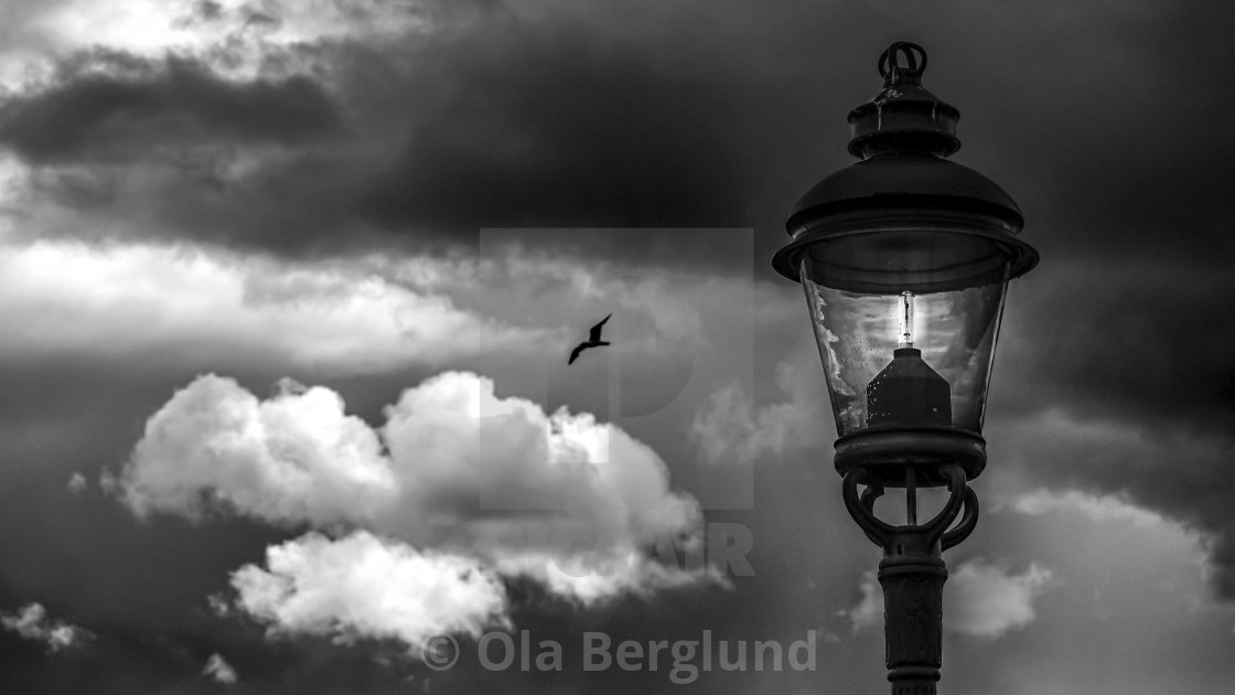 "Lamp and dark clouds." stock image