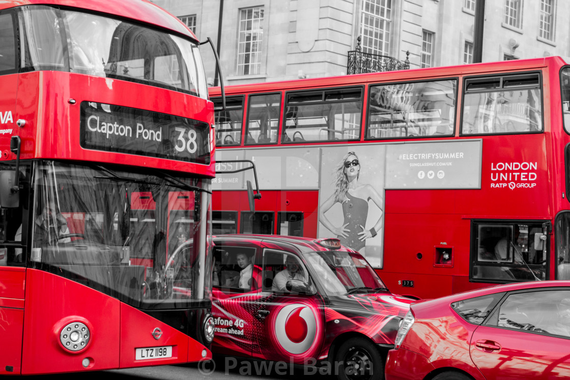 "Red buses and cars in London" stock image