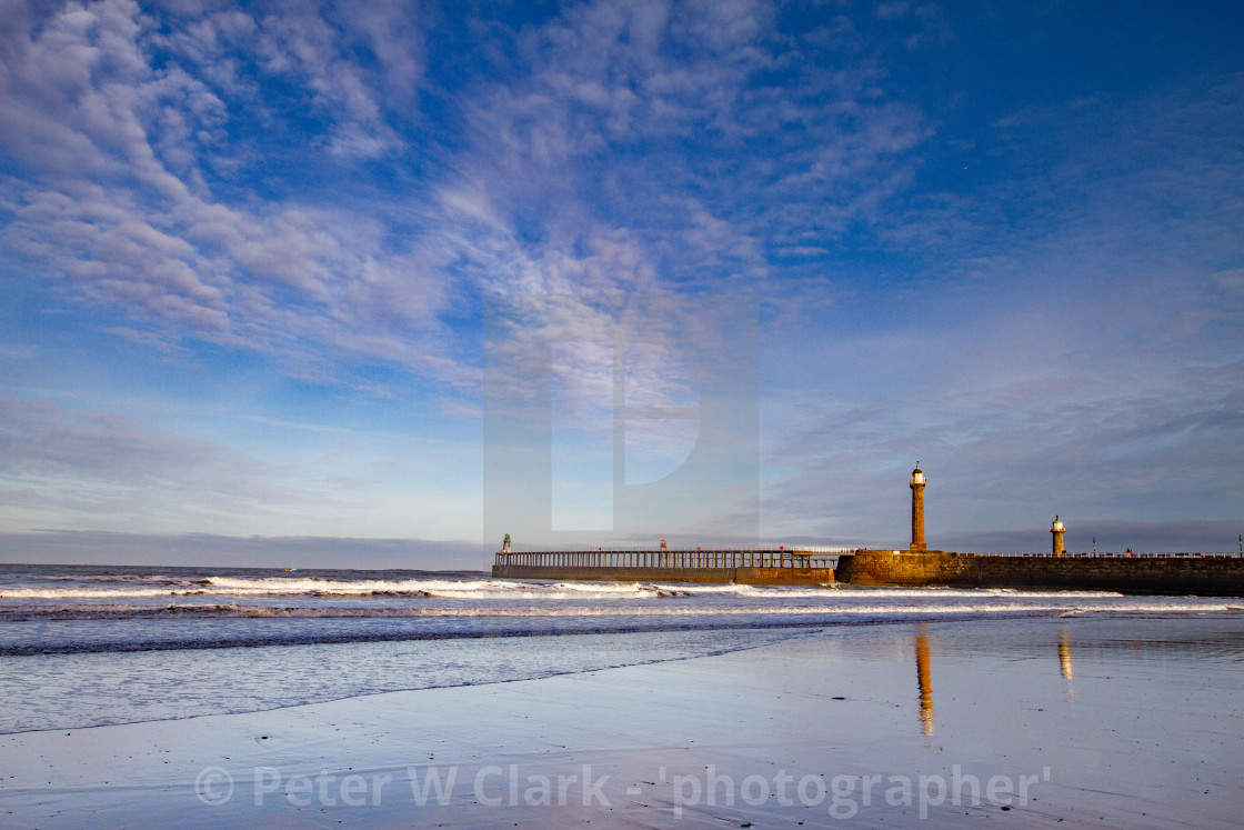 "Whitby, UK, Beach, Pier,lighthouse and Reflection. Blue Sky and Copy Space." by Peter W. Clark - 'photographer' - £20.00 "Whitby, UK, Beach, Pier,lighthouse and Reflection. Blue Sky and Copy Space." stock image