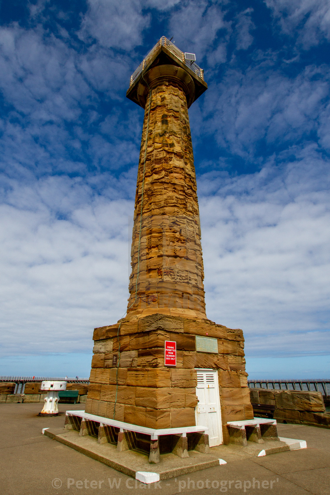 "Whitby,UK,Yorkshire,East coast, West Pier Old Lighthouse. Capstan in the Background." by Peter W. Clark - 'photographer' - £10.00 "Whitby,UK,Yorkshire,East coast, West Pier Old Lighthouse. Capstan in the Background." stock image