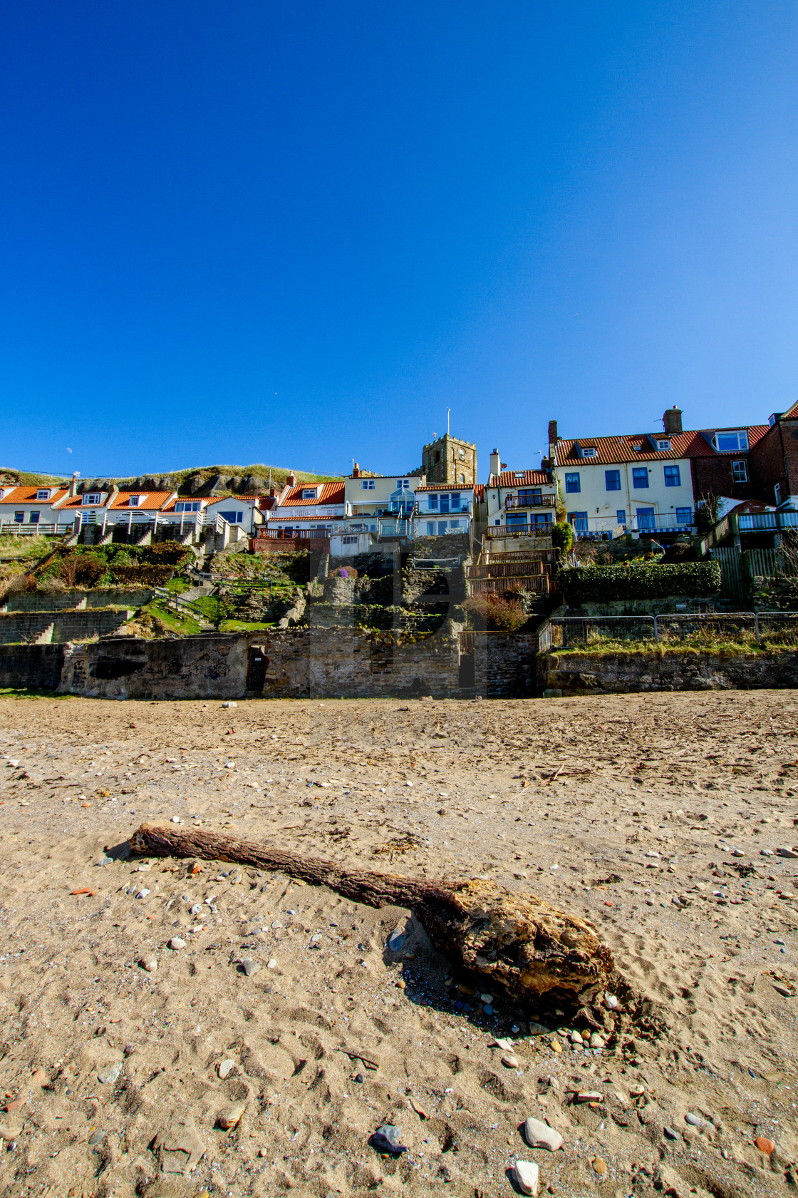 "Whitby,UK,Yorkshire,East coast, Collier Hope Beach and Driftwood, Tiered Gardens and St Mary's Church in the Background. Photographed April 2013." by Peter W. Clark - 'photographer' - £20.00 "Whitby,UK,Yorkshire,East coast, Collier Hope Beach and Driftwood, Tiered Gardens and St Mary's Church in the Background. Photographed April 2013." stock image