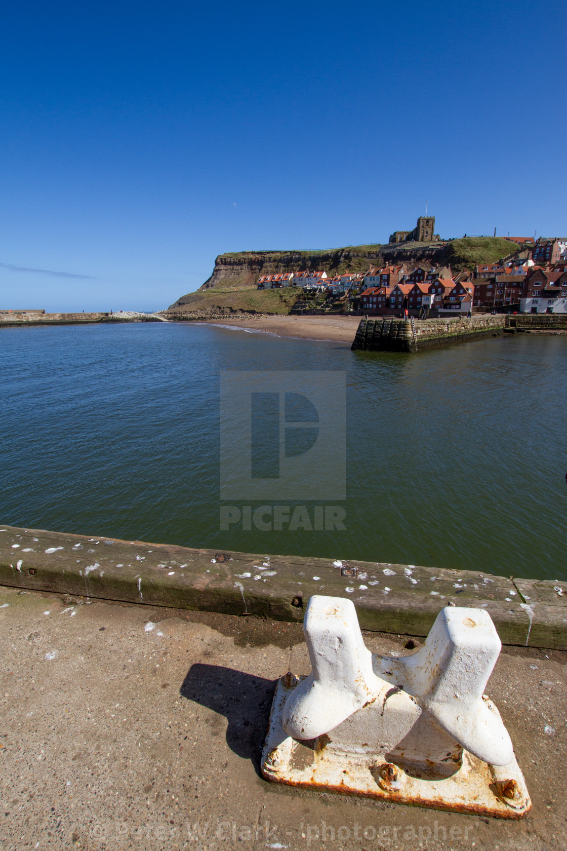 "Whitby,UK,Yorkshire,East coast, View across the Lower Harbour towards Tate Hill Pier and Sands. St Mary's Church in the background, ship Mooring Bollard in the Foreground. Photograph taken on a sunny day, April 2013" by Peter W. Clark - 'photographer' - £20.00 "Whitby,UK,Yorkshire,East coast, View across the Lower Harbour towards Tate Hill Pier and Sands. St Mary's Church in the background, ship Mooring Bollard in the Foreground. Photograph taken on a sunny day, April 2013" stock image