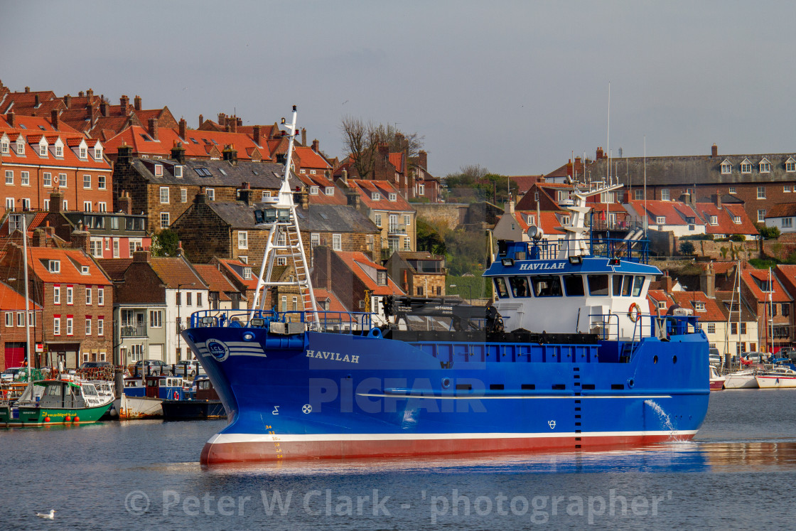 "Havilah a Cargo Vessel Departing Whitby Harbour, a Port on the Yorkshire East Coast." by Peter W. Clark - 'photographer' - £10.00 "Havilah a Cargo Vessel Departing Whitby Harbour, a Port on the Yorkshire East Coast." stock image