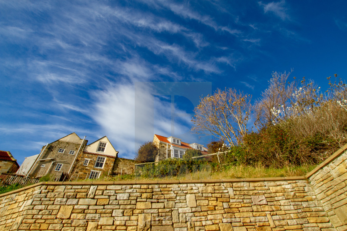 "Cottages above the sea wall, rear view. Robin Hoods Bay. External rear view on a sunny day." by Peter W. Clark - 'photographer' - £15.00 "Cottages above the sea wall, rear view. Robin Hoods Bay. External rear view on a sunny day." stock image