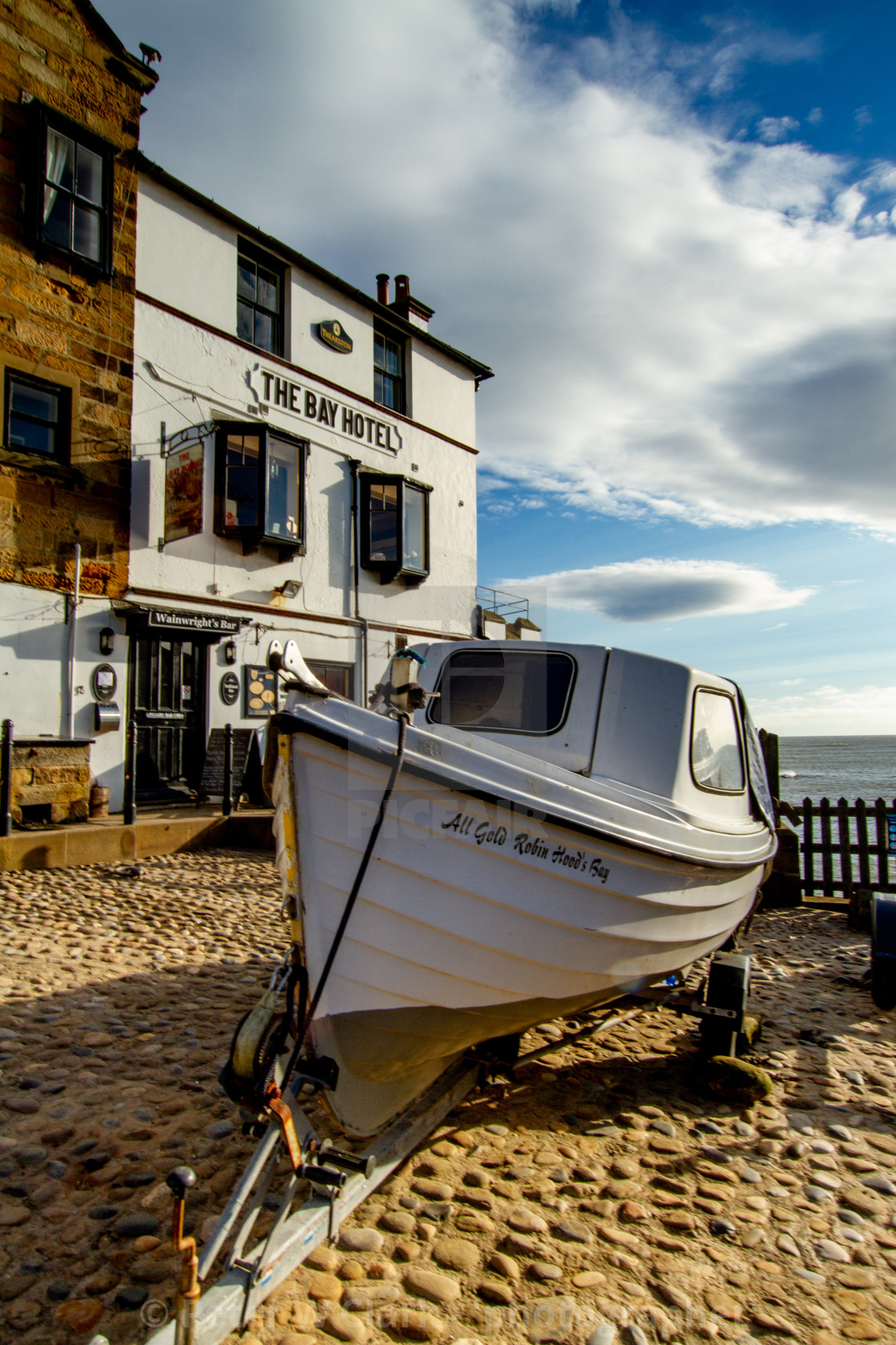 "Robin Hoods Bay, Yorkshire. Fishing boat on trailer in front of The Bay Hotel." by Peter W. Clark - 'photographer' - £15.00 "Robin Hoods Bay, Yorkshire. Fishing boat on trailer in front of The Bay Hotel." stock image