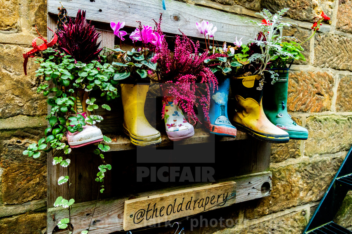 "Flowers displayed in Quirky Wellingtons at the Old Drapery, Robin Hoods Bay, Yorkshire." by Peter W. Clark - 'photographer' - £10.00 "Flowers displayed in Quirky Wellingtons at the Old Drapery, Robin Hoods Bay, Yorkshire." stock image