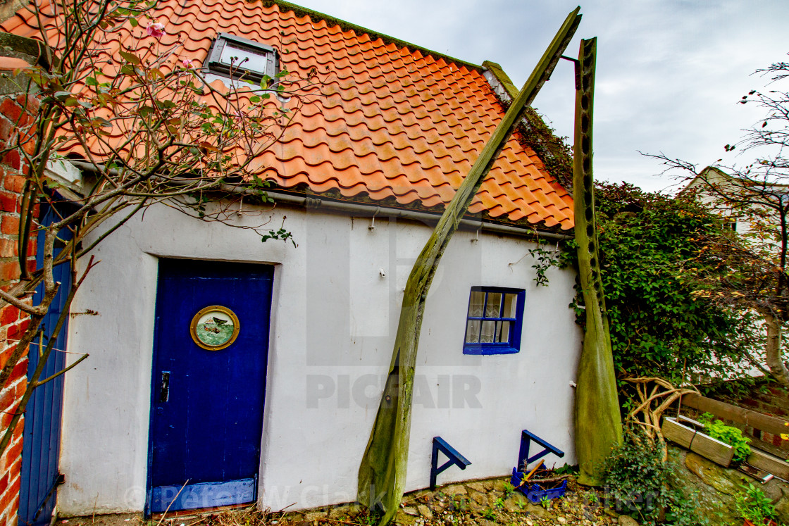"Cottage in Robin Hoods Bay with Whalebone Arch in Garden." by Peter W. Clark - 'photographer' - £15.00 "Cottage in Robin Hoods Bay with Whalebone Arch in Garden." stock image