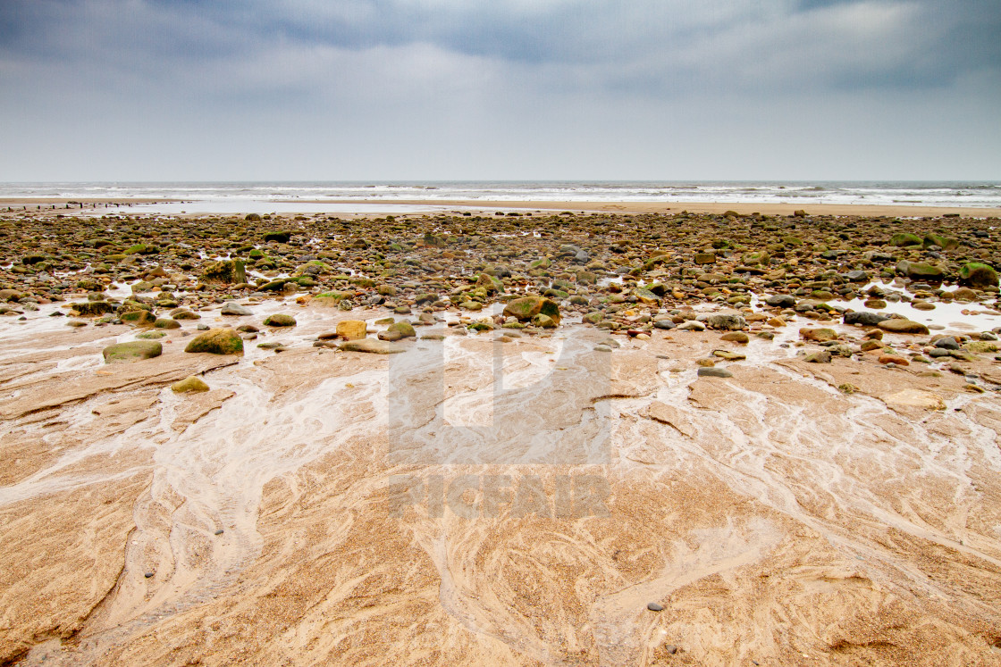 "Sandsend, Yorkshire, England. Looking across the beach towards the North Sea." by Peter W. Clark - 'photographer' - £20.00 "Sandsend, Yorkshire, England. Looking across the beach towards the North Sea." stock image