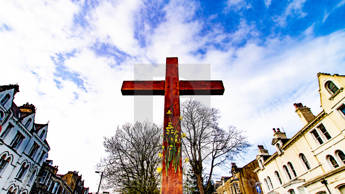 "Easter Cross with Daffodils, top of Brook Street, Ilkley ,Yorkshire, England, UK." stock image