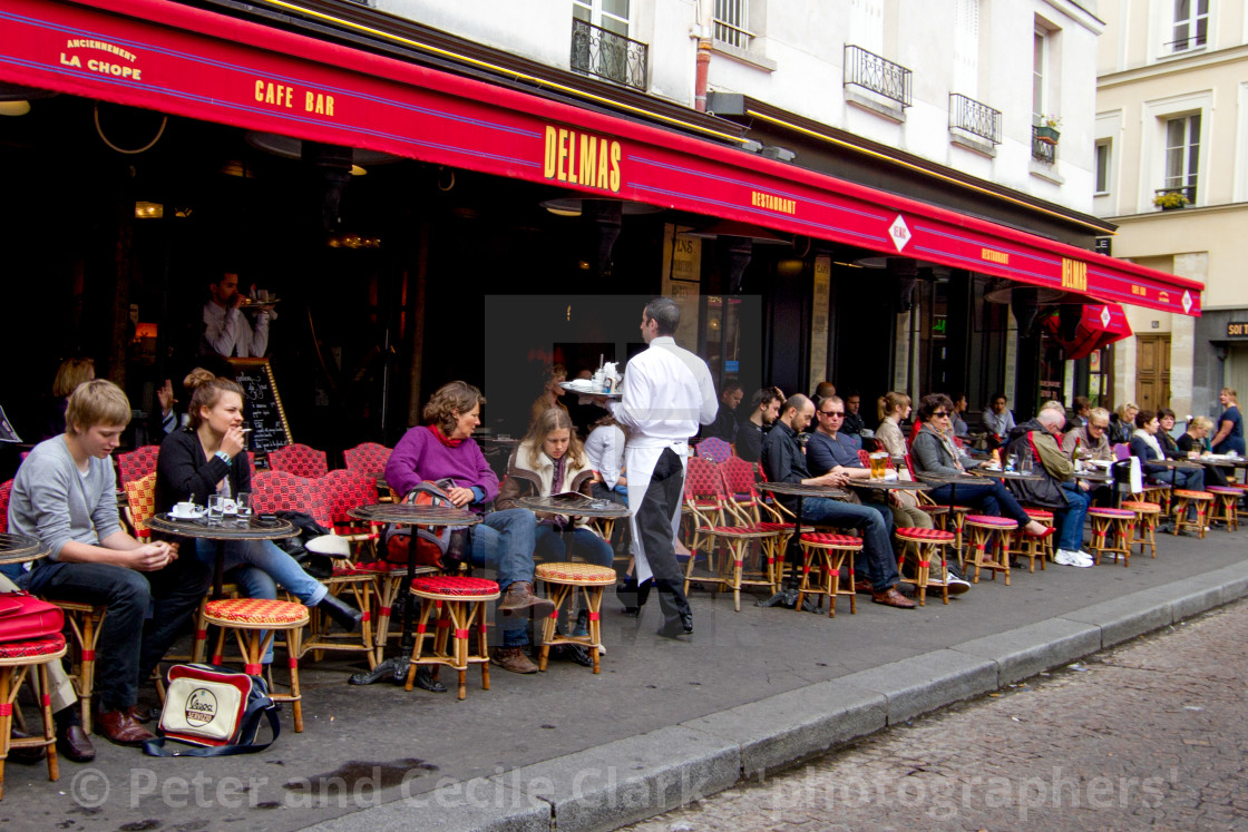 "Waiter serving Coffee at a Pavement Cafe in Paris" stock image