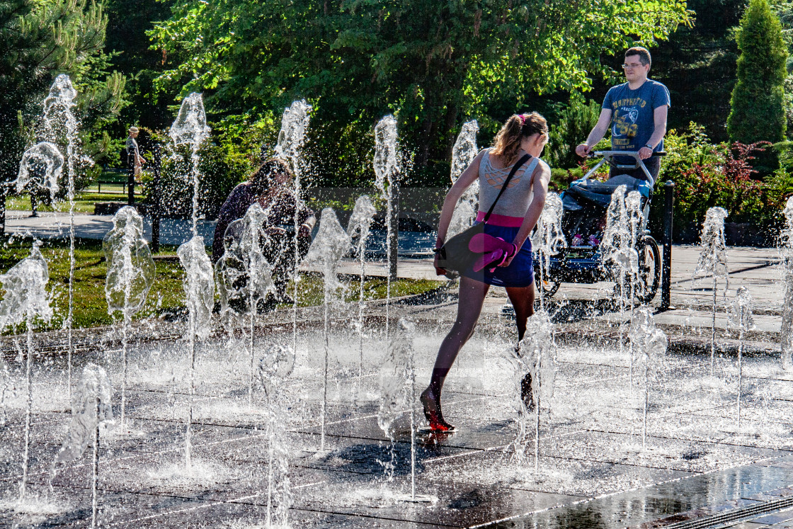 "Girl running through The Fountain on The Promenade, Swinoujscie, Poland." stock image