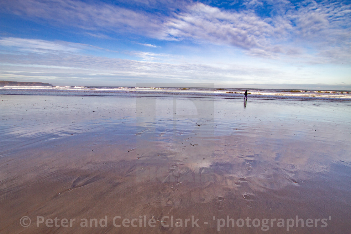 "Whitby, UK, Beach, Lone Walker and Reflection. Blue Sky and Copy Space." stock image