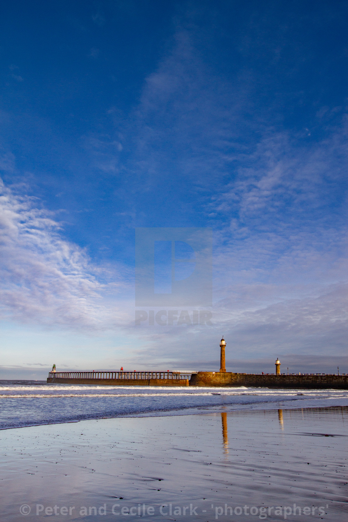 "Whitby, UK, Beach, Pier,lighthouse and Reflection. Blue Sky and Copy Space." stock image