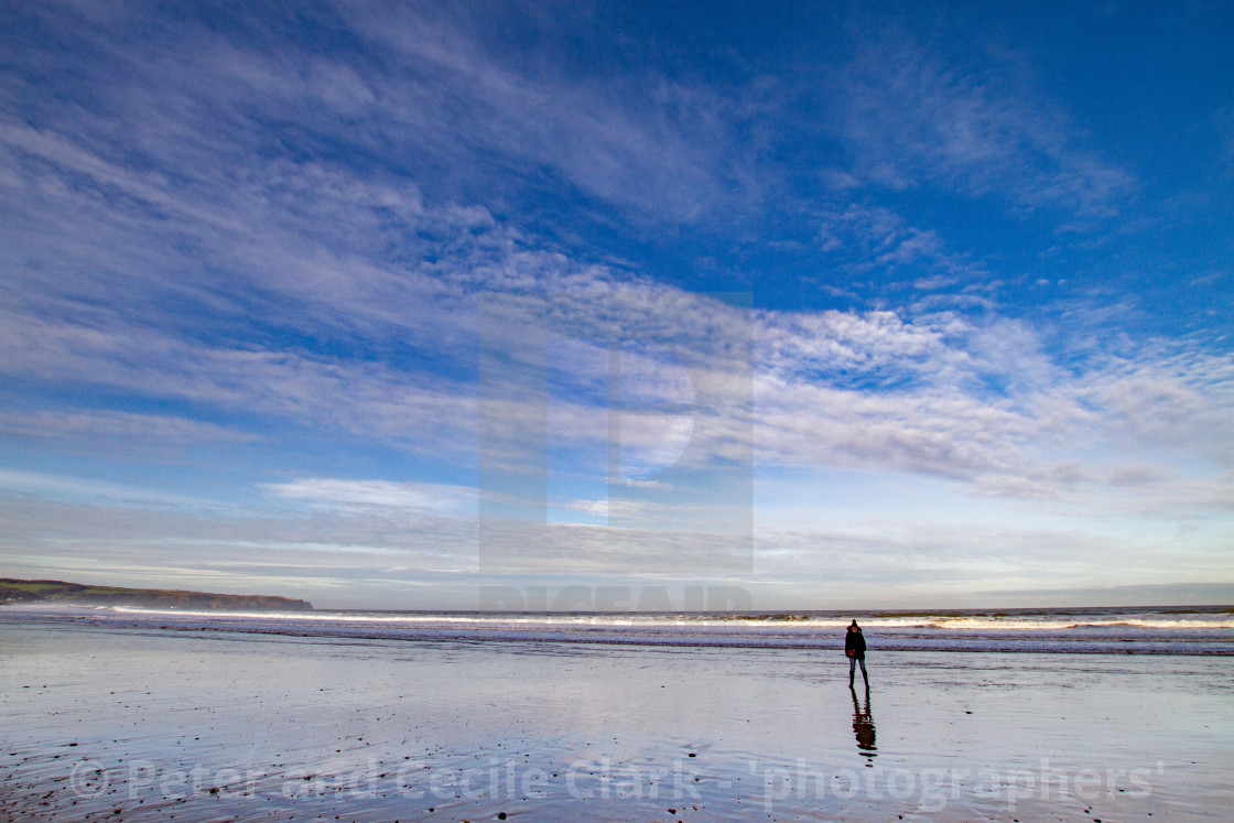 "Whitby, UK, Beach, Lone Walker and Reflection. Blue Sky and Copy Space." stock image