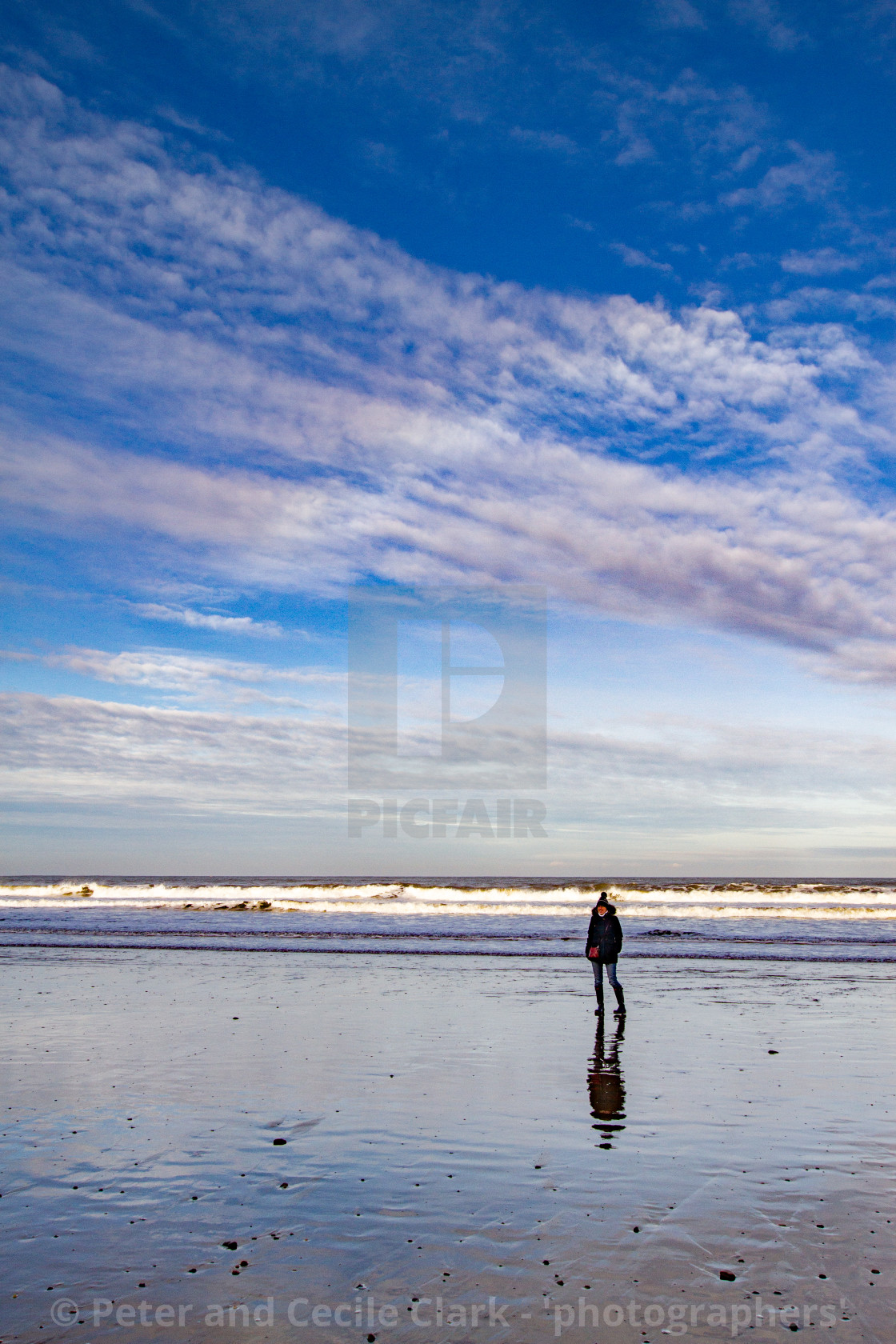 "Whitby, UK, Beach, Lone Walker and Reflection. Blue Sky and Copy Space." stock image