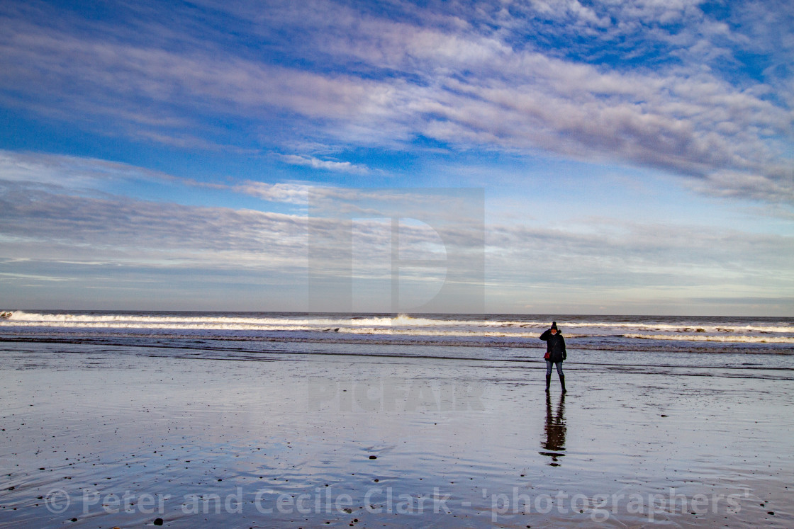 "Whitby, UK, Beach, Lone Walker and Reflection. Blue Sky and Copy Space." stock image